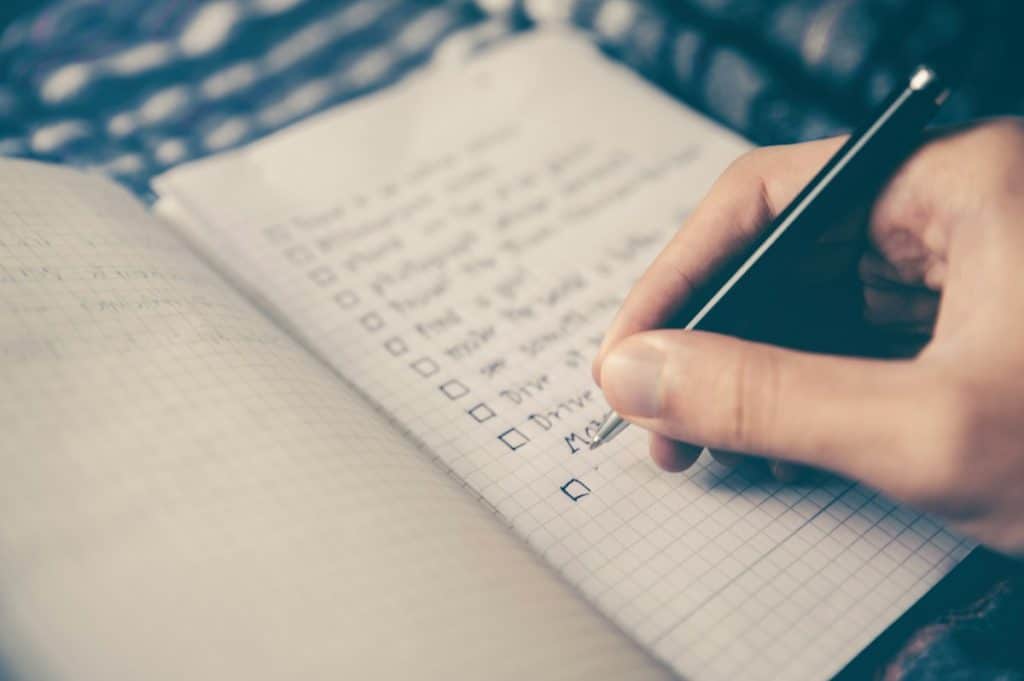 Notebook with a handwritten checklist on a desk